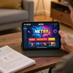 NET88 gaming enthusiast placing bets on the tablet while tracking strategies in a cozy setup.